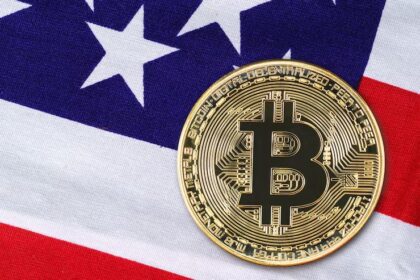 Howard Lutnick speaking with a U.S. flag and Bitcoin symbol glowing behind him, symbolizing Bitcoin’s growing status as "digital gold" in the Trump-era economic landscape.