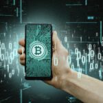 Hand holding smartphone with digital interface and blockchain icons, representing NFT and crypto services.