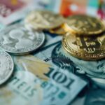 Various global fiat currencies alongside Bitcoin, symbolizing rising cryptocurrency adoption amid geopolitical and economic uncertainty.