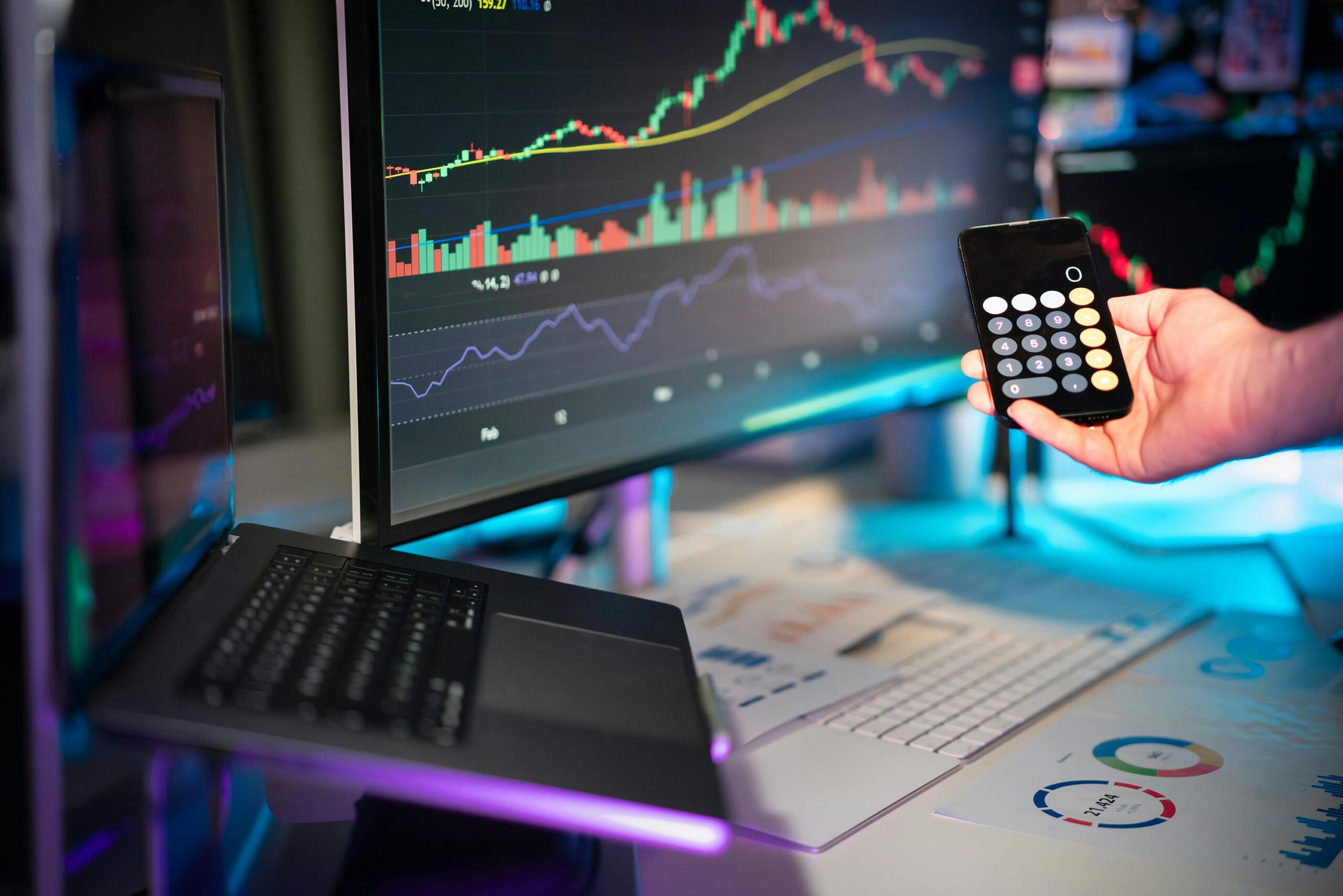 Person analyzing crypto charts on multiple monitors with Bitcoin and Ethereum price drops visible.