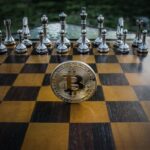 Chessboard with Bitcoin coin among glass pieces, symbolizing strategic investment moves in crypto.