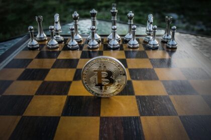 Chessboard with Bitcoin coin among glass pieces, symbolizing strategic investment moves in crypto.